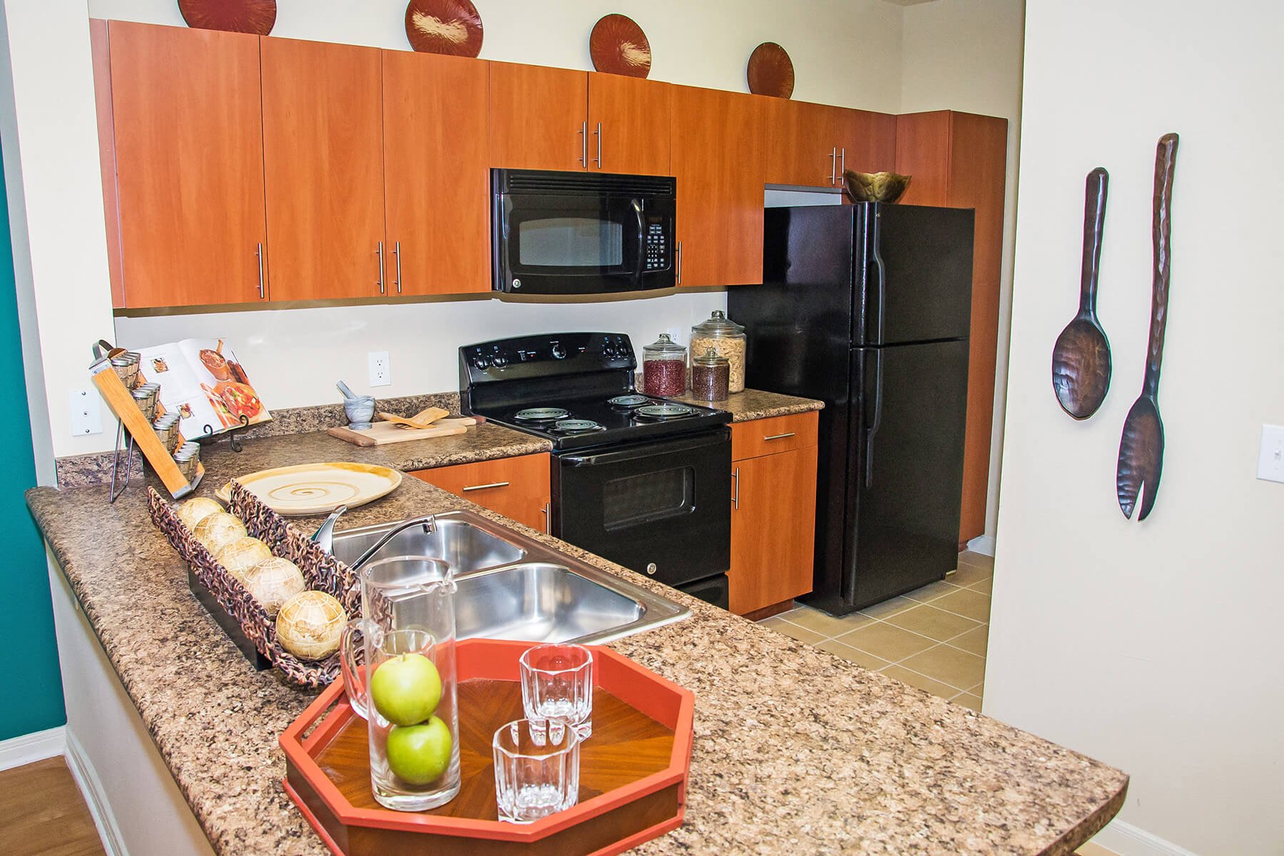 A bright kitchen with a countertop bar at the Lakeland Estates Apartments in Stafford, Texas.